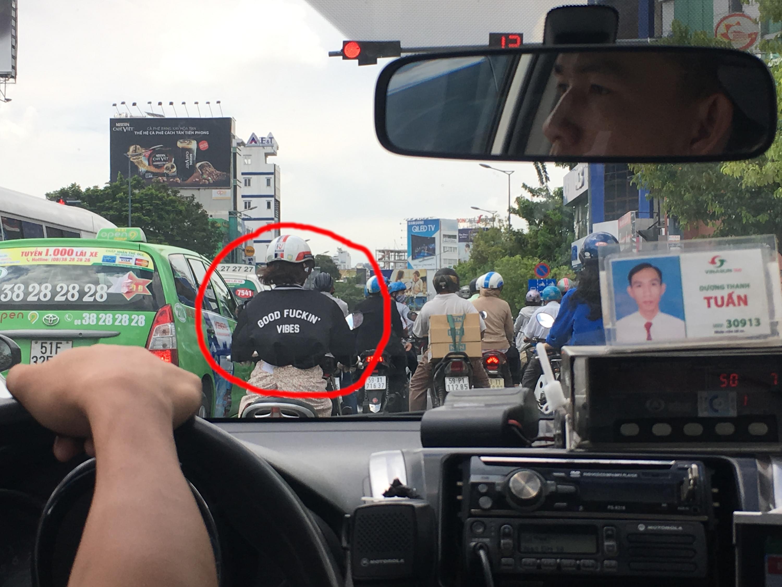 On arrival in Saigon, in the back of a cab, Dave spots a motorbike driver with a jacket saying "Good Fuckin' Vibes"