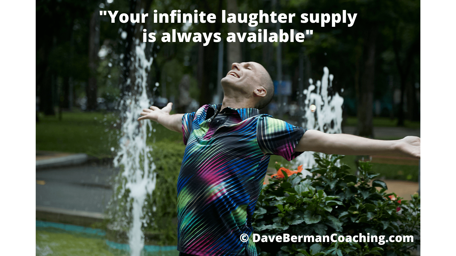 Dave Berman stands in a Saigon park with fountains around him, his arms spread wide, head tilted back, laughing. The caption says: "Your infinite laughter supply is always available." © DaveBermanCoaching.com